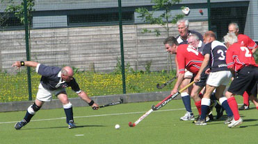 Ken Wilcox breaks through the Scottish defence
               past Scottish GGM Captain David Cassell
